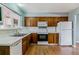 Functional kitchen featuring durable countertops, traditional cabinetry, and essential appliances at 16588 E 8Th Ave, Aurora, CO 80011