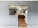 View into kitchen with dark wood cabinets and a white refrigerator and stove at 16588 E 8Th Ave, Aurora, CO 80011