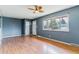 Spacious living room with hardwood floors, large windows, and a ceiling fan at 16588 E 8Th Ave, Aurora, CO 80011