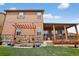 Charming two-story home boasts a spacious backyard with a covered patio, stone accents and a lovely pergola swing at 436 Sage Grouse Cir, Castle Rock, CO 80109