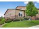 Beautiful landscaped backyard with green grass, mature trees, and privacy fence at 436 Sage Grouse Cir, Castle Rock, CO 80109