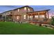 A lush backyard with a covered patio, swing, and manicured lawn at 436 Sage Grouse Cir, Castle Rock, CO 80109