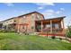 Expansive backyard with a covered patio, pergola swing, stone accents and a lush lawn create an outdoor oasis at 436 Sage Grouse Cir, Castle Rock, CO 80109