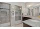 Bathroom featuring dual vanities, granite countertops, and a stylish tile shower with glass door at 436 Sage Grouse Cir, Castle Rock, CO 80109