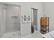 Modern bathroom featuring dual shower stalls, towel bars, and a corner wooden shelf unit at 436 Sage Grouse Cir, Castle Rock, CO 80109