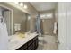 Clean bathroom design featuring dual sinks, dark wood cabinets, and a tub-shower combination at 436 Sage Grouse Cir, Castle Rock, CO 80109