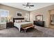 Bright bedroom with a ceiling fan, carpet flooring, plantation shutters, and neutral walls at 436 Sage Grouse Cir, Castle Rock, CO 80109