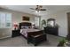 Cozy bedroom with plantation shutters, carpet floors, ceiling fan, and dark wood furniture at 436 Sage Grouse Cir, Castle Rock, CO 80109