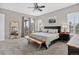 Well-lit primary bedroom with a ceiling fan, carpet flooring, plantation shutters, and access to a balcony at 436 Sage Grouse Cir, Castle Rock, CO 80109
