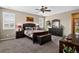 Comfortable bedroom featuring dark wood furnishings and a decorative ceiling fan with light at 436 Sage Grouse Cir, Castle Rock, CO 80109