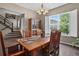 Dining room with wood table, large windows, and staircase access at 436 Sage Grouse Cir, Castle Rock, CO 80109