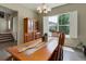 Dining room with a wood table, large windows with blinds, and staircase access at 436 Sage Grouse Cir, Castle Rock, CO 80109