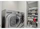 Laundry room features a washer/dryer, shelves for linen, a trash bin, and a striped rug at 436 Sage Grouse Cir, Castle Rock, CO 80109