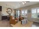 Comfortable living area with leather chairs, decorative mirror, and natural lighting at 436 Sage Grouse Cir, Castle Rock, CO 80109