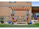 Cozy backyard pergola swing invites relaxation with its stone base, wood frame and decorative blue accents at 436 Sage Grouse Cir, Castle Rock, CO 80109