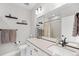 Bright bathroom with a single sink, modern fixtures, sleek vanity, and a shower, combining style and functionality at 6792 Navajo Way, Denver, CO 80221