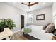 Bright bedroom features a ceiling fan, closet, wood floor and stylish decor at 6792 Navajo Way, Denver, CO 80221
