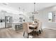 Spacious dining area featuring a chandelier, modern kitchen with stainless steel appliances, and a breakfast bar at 6792 Navajo Way, Denver, CO 80221
