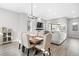 Bright dining area boasts a rustic wooden table, comfortable upholstered chairs, and an open floor plan with modern finishes at 6792 Navajo Way, Denver, CO 80221
