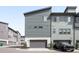 Modern townhome boasts attached garages, landscaping, and stylish exterior at 6792 Navajo Way, Denver, CO 80221