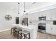 Modern kitchen with a large island, stainless steel appliances, and stylish pendant lighting at 6792 Navajo Way, Denver, CO 80221