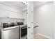 Laundry room has modern LG washer and dryer, shelves, and ample storage at 6792 Navajo Way, Denver, CO 80221