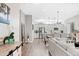 Bright open floor plan showcases modern kitchen and dining area with stainless appliances and wood flooring at 6792 Navajo Way, Denver, CO 80221