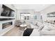 Inviting living area with sleek fireplace, large TV, comfortable seating, and natural light at 6792 Navajo Way, Denver, CO 80221