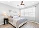 Serene main bedroom with a comfortable bed, soft lighting, sheer curtains, and a ceiling fan for ultimate relaxation at 6792 Navajo Way, Denver, CO 80221
