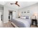 Comfortable main bedroom featuring a ceiling fan, soothing decor, and a walk-in closet, providing ample storage and relaxation at 6792 Navajo Way, Denver, CO 80221