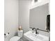 Contemporary powder room featuring a floating sink, sleek fixtures, and minimalist decor, creating a clean and stylish space at 6792 Navajo Way, Denver, CO 80221