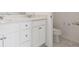 Bathroom features a double sink vanity with white cabinets at 6814 Merseyside Ln, Castle Pines, CO 80108