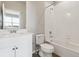 Clean, bright bathroom with a single sink vanity, toilet, and shower-tub combo at 6814 Merseyside Ln, Castle Pines, CO 80108
