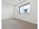 Neutral bedroom with carpeted floor and a large window providing natural light at 6814 Merseyside Ln, Castle Pines, CO 80108