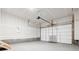 Spacious garage with white walls and a large garage door at 6814 Merseyside Ln, Castle Pines, CO 80108