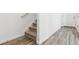Hallway with carpeted stairs and LVP flooring at 6814 Merseyside Ln, Castle Pines, CO 80108