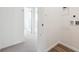 Hallway with gray carpet and LVP flooring and bright white walls at 6814 Merseyside Ln, Castle Pines, CO 80108