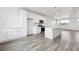 Open concept kitchen features an island, modern appliances and pendant lighting, creating a seamless living space at 6814 Merseyside Ln, Castle Pines, CO 80108