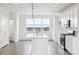 Bright, spacious kitchen with white cabinets, island with sink, and stainless steel appliances at 6814 Merseyside Ln, Castle Pines, CO 80108