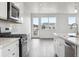Modern kitchen features white cabinets and stainless steel appliances at 6814 Merseyside Ln, Castle Pines, CO 80108