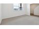 Bright living room with carpet, large window and view of the staircase at 6814 Merseyside Ln, Castle Pines, CO 80108