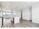 Spacious living room featuring hardwood floors, recessed lighting, with access to an open concept kitchen at 6814 Merseyside Ln, Castle Pines, CO 80108
