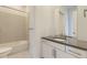 Bathroom featuring a tub with tiled wall and vanity with large mirror at 3877 Treadway Pt, Castle Rock, CO 80108
