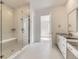 Luxurious bathroom featuring a glass-enclosed shower, dual sinks, and stylish modern finishes at 3877 Treadway Pt, Castle Rock, CO 80108