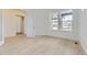 Bright bedroom with hardwood floors, a modern door, and expansive windows offer plenty of natural light at 3877 Treadway Pt, Castle Rock, CO 80108