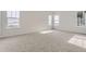 Spacious bedroom featuring neutral carpeting and large windows offering plenty of natural light and neighborhood views at 3877 Treadway Pt, Castle Rock, CO 80108
