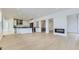 Spacious open-concept living area and modern kitchen featuring sleek hardwood floors and ample natural light at 3877 Treadway Pt, Castle Rock, CO 80108