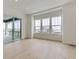 Open living area with hardwood floors, big windows, and sliding door to deck at 3877 Treadway Pt, Castle Rock, CO 80108