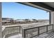 View from deck overlooking neighboring houses and open field at 3877 Treadway Pt, Castle Rock, CO 80108