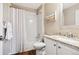 Bright bathroom featuring a shower-tub, granite countertop, and warm beige walls at 6033 Trailhead Rd, Highlands Ranch, CO 80130